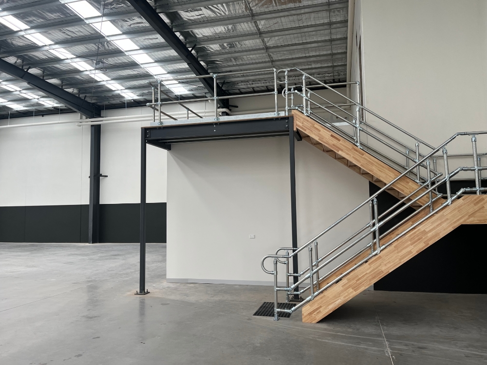 Interclamp double rail handrail systems with toeboard installed on a mezzanine floor.